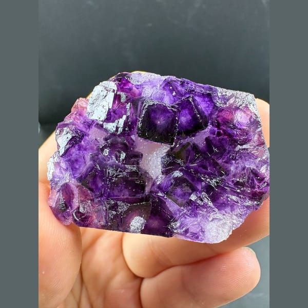 Glassy deep purple fluorite crystal group from Henan — complete view