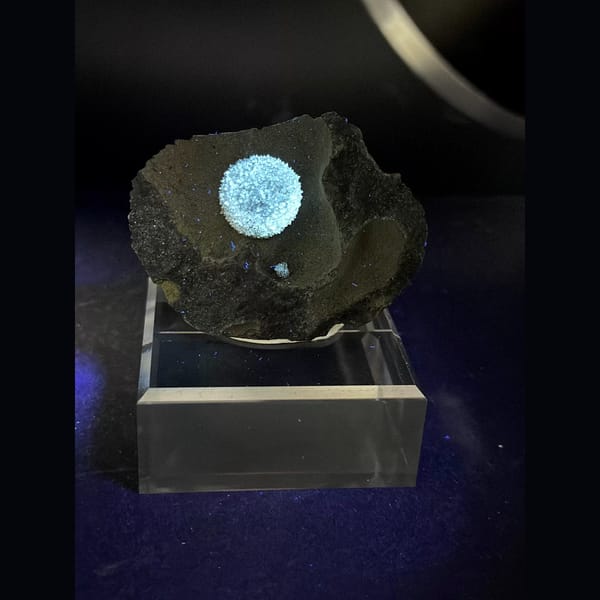 Round radiating calcite ball on dark matrix from Vietnam — alternate view