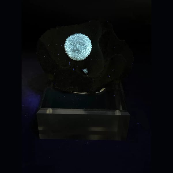 Round radiating calcite ball on dark matrix from Vietnam — alternate view