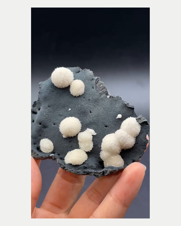 Complete raised oblique view of white spherical Vietnamese calcite