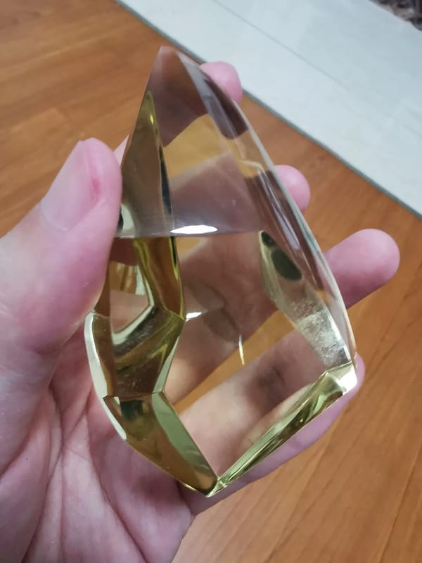 Complete angled view showing broad facets on the same yellow quartz freeform
