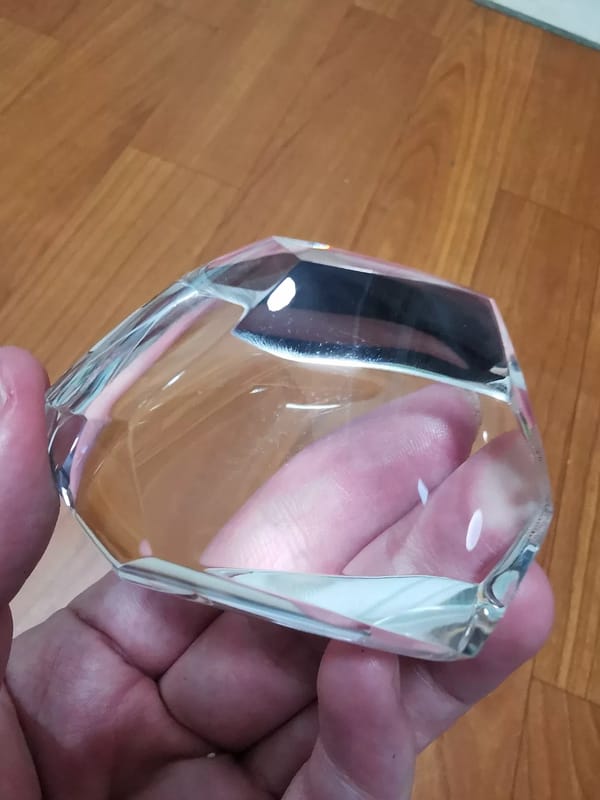 Complete side view showing the broad facets of the clear quartz freeform