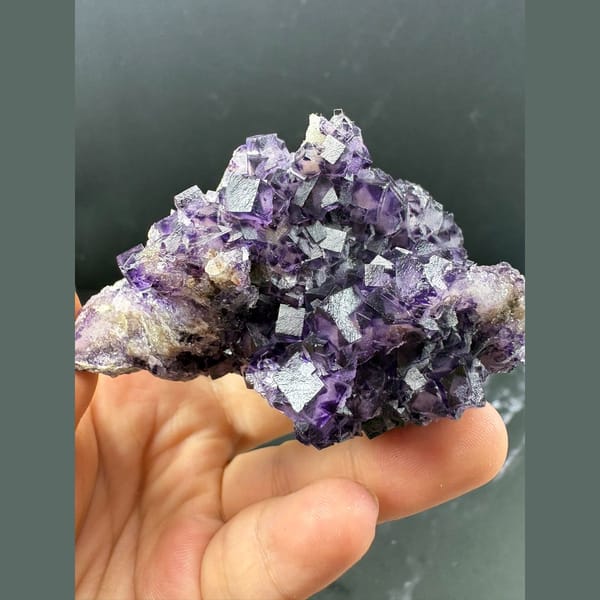 Purple fluorite with pale-windowed faces and candle quartz from Luoyang — detail view