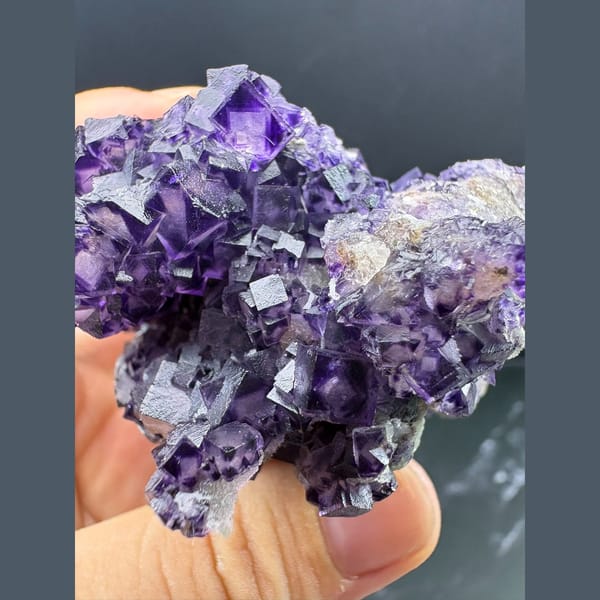 Purple fluorite with pale-windowed faces and candle quartz from Luoyang — detail view