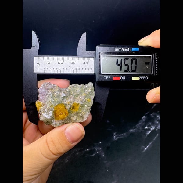 Golden yellow barite crystals on pale green fluorite from Ruijin — detail view