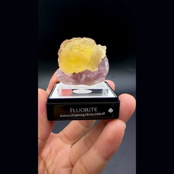 Yellow fluorite ball on purple fluorite from Zhejiang — detail view
