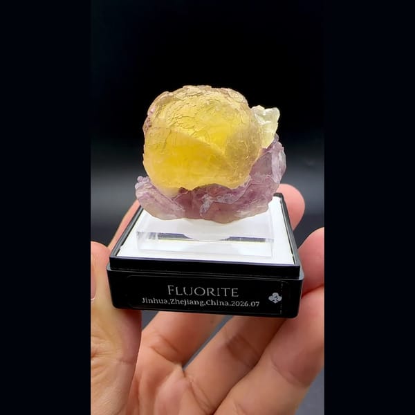 Yellow fluorite ball on purple fluorite from Zhejiang — detail view