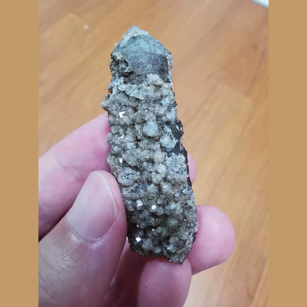 Quartz crystal covered in sparkling fluorite — detail view