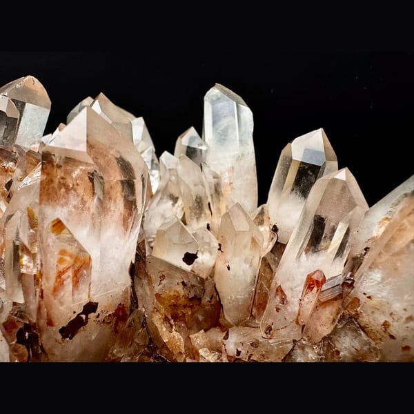 Large clear quartz cluster with red iron coating from Madagascar — detail view
