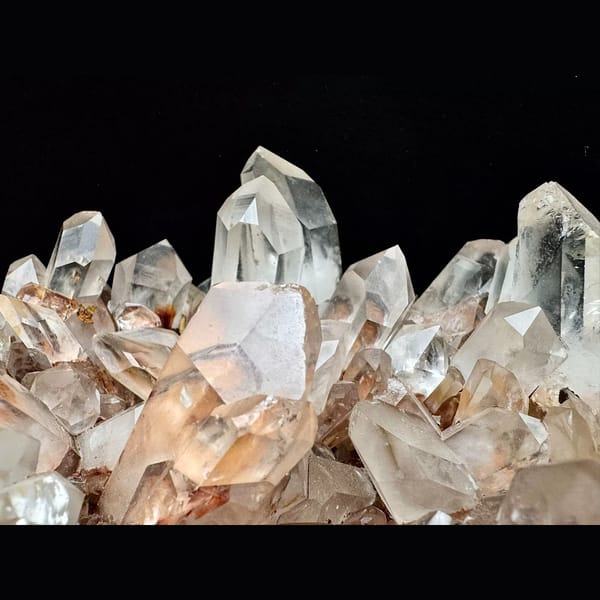 Large clear quartz cluster with red iron coating from Madagascar — detail view