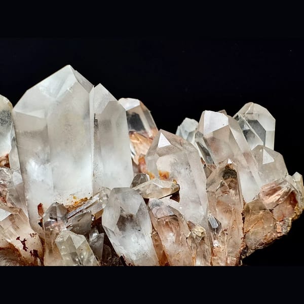 Large clear quartz cluster with red iron coating from Madagascar — detail view
