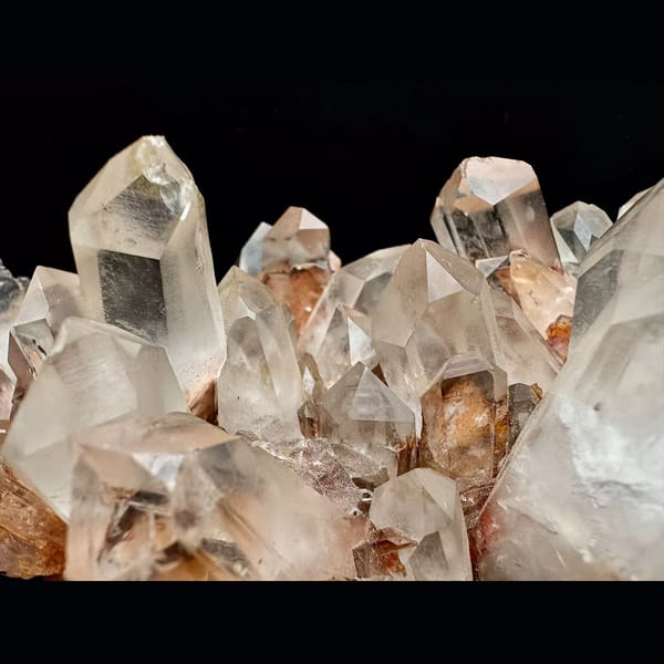 Large clear quartz cluster with red iron coating from Madagascar — detail view