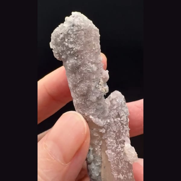 Double-terminated quartz with pink calcite and hematite rosette from Inner Mongolia — detail view