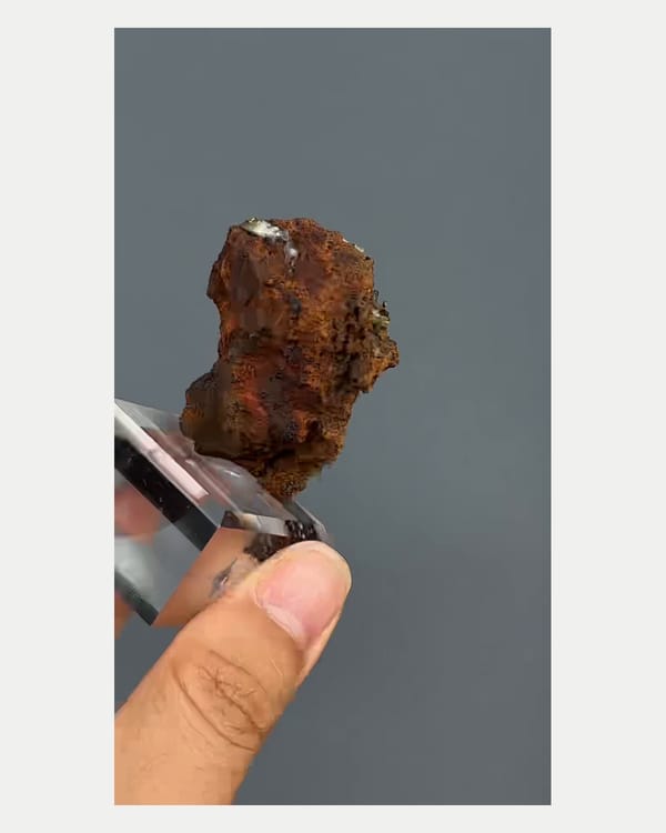 Complete right oblique view of pale yellow adamite on brown matrix