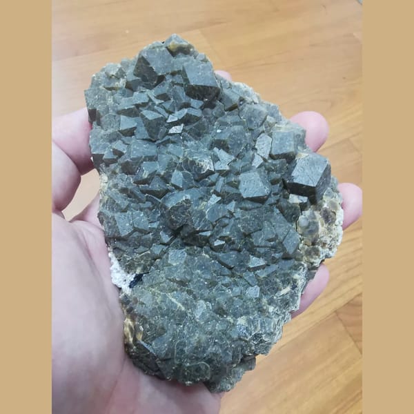 Large green garnet with specular hematite and quartz — complete view