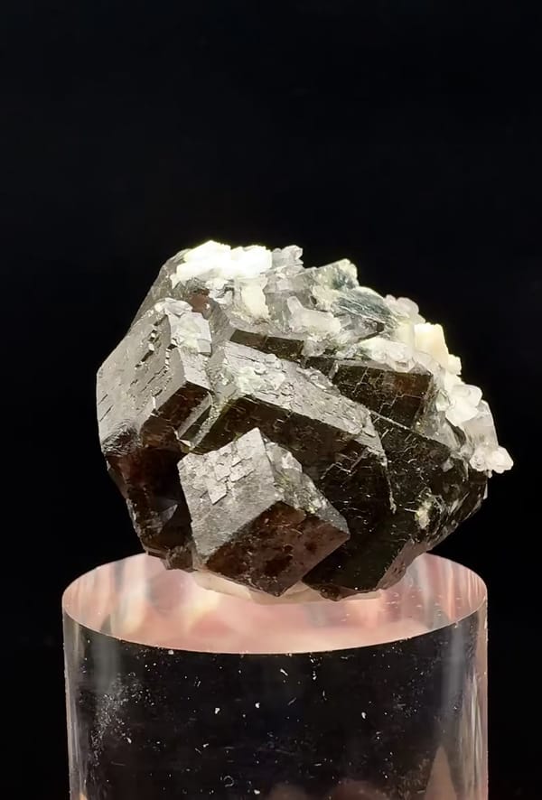 Complete upper side showing the same angular garnet crystals with pale associated material