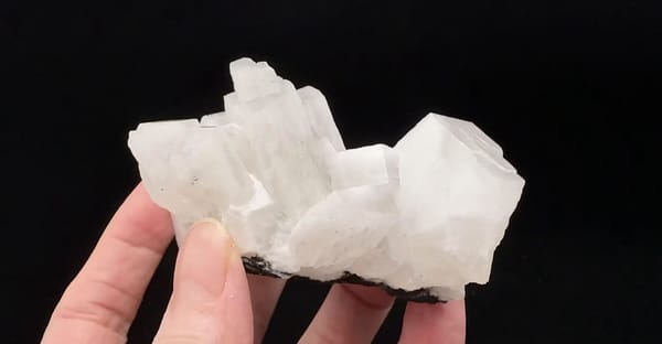 Complete opposite side showing the stepped white calcite growth and dark base