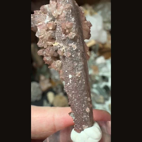 Quartz crystal crowned by red-to-white calcite sprays from Inner Mongolia — detail view