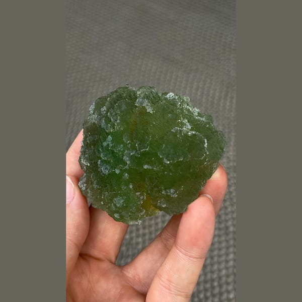 Large stepped apple green fluorite cluster from Henan — detail view