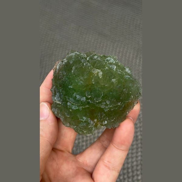 Large stepped apple green fluorite cluster from Henan — detail view