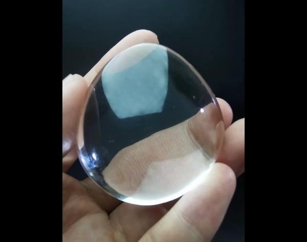 Complete front view of the exact polished clear quartz palm stone