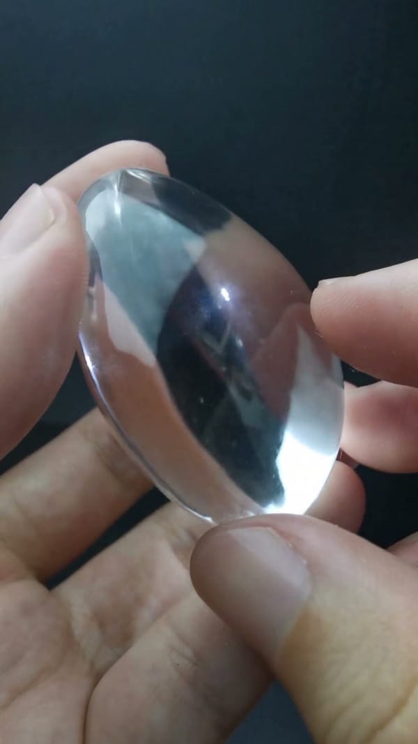 Complete narrow side view of the same polished clear quartz piece