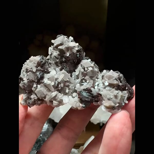 Dark andradite garnet with bladed hematite and grey-pink calcite from Inner Mongolia — complete view
