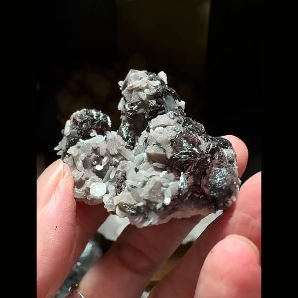 Dark andradite garnet with bladed hematite and grey-pink calcite from Inner Mongolia — alternate view