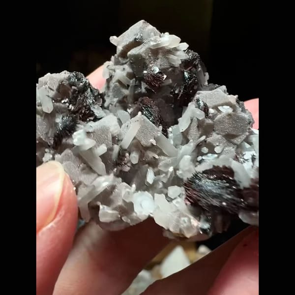 Dark andradite garnet with bladed hematite and grey-pink calcite from Inner Mongolia — alternate view