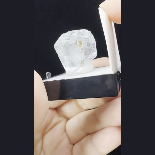 Small glassy colourless fluorite crystal from Yaogangxian, Hunan — complete view
