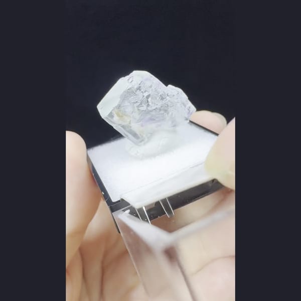 Small glassy colourless fluorite crystal from Yaogangxian, Hunan — alternate view
