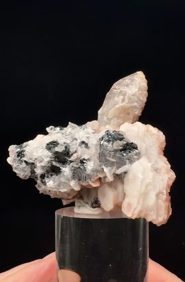 Complete reverse showing the pink-white calcite and shiny dark specular hematite