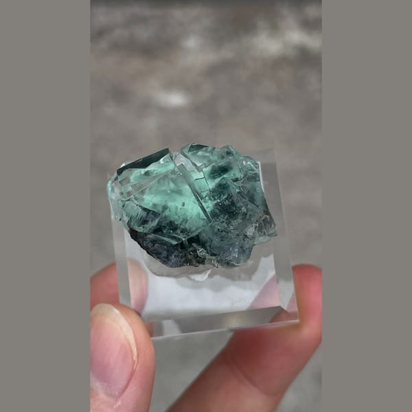 Transparent teal-green fluorite with wispy inclusions from Hunan — detail view