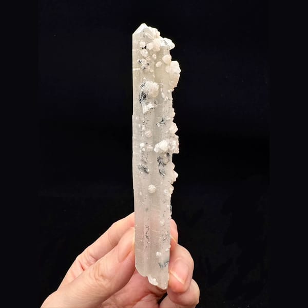 Slender quartz floater with pale pink calcite and specular hematite from Inner Mongolia — complete view