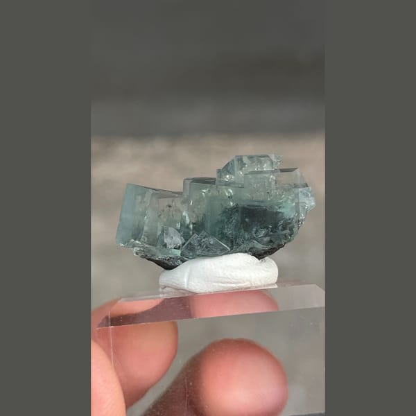 Transparent teal fluorite with wispy inclusions from Xianghualing, Hunan — complete view