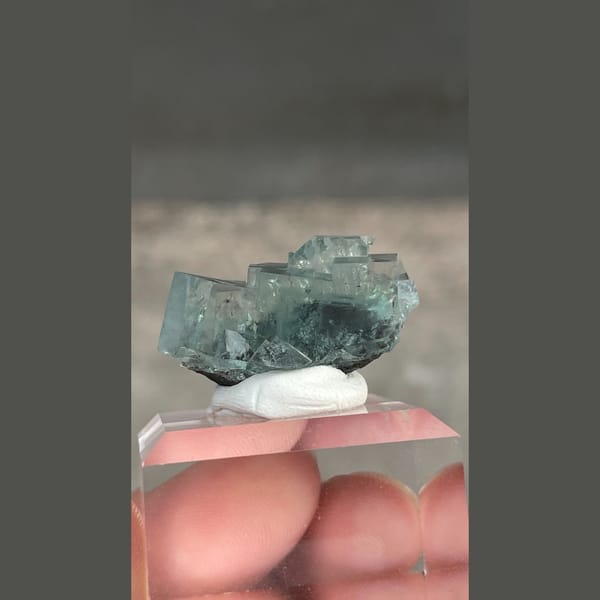 Transparent teal fluorite with wispy inclusions from Xianghualing, Hunan — detail view