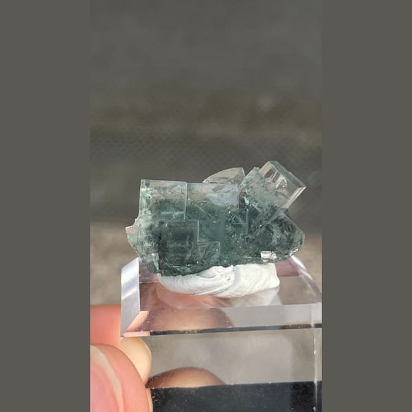 Transparent teal fluorite with wispy inclusions from Xianghualing, Hunan — detail view