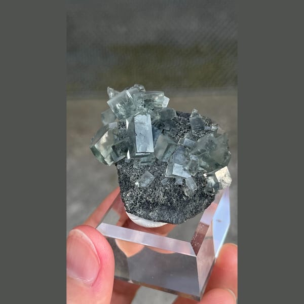 Transparent teal fluorite crystals on dark matrix from Hunan — alternate view