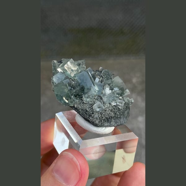 Transparent teal fluorite crystals on dark matrix from Hunan — alternate view