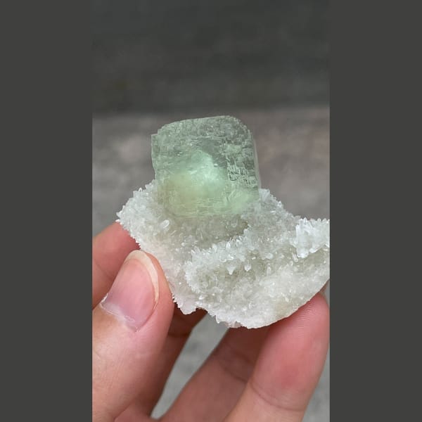 Stepped mint-green fluorite cube on white quartz from Fujian — complete view