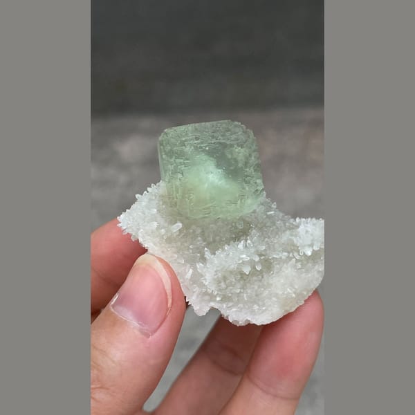 Stepped mint-green fluorite cube on white quartz from Fujian — alternate view