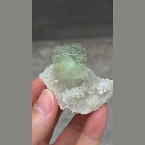 Stepped mint-green fluorite cube on white quartz from Fujian — alternate view