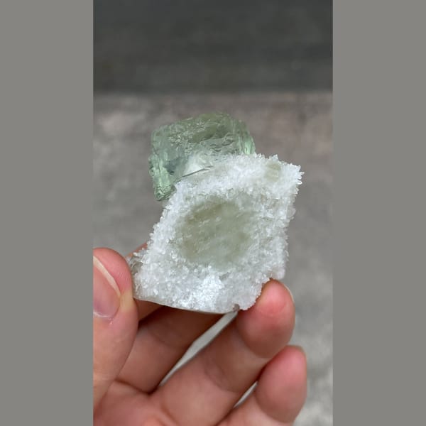 Stepped mint-green fluorite cube on white quartz from Fujian — detail view