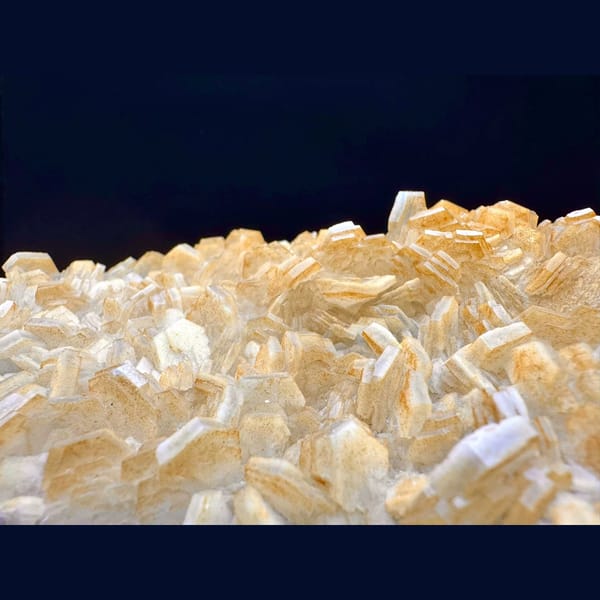 Pale yellow layered calcite blades on a plate from Fujian — alternate view