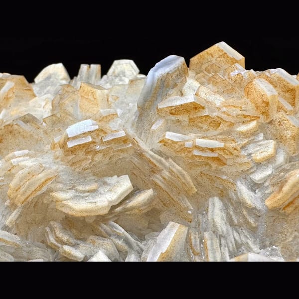 Pale yellow layered calcite blades on a plate from Fujian — detail view