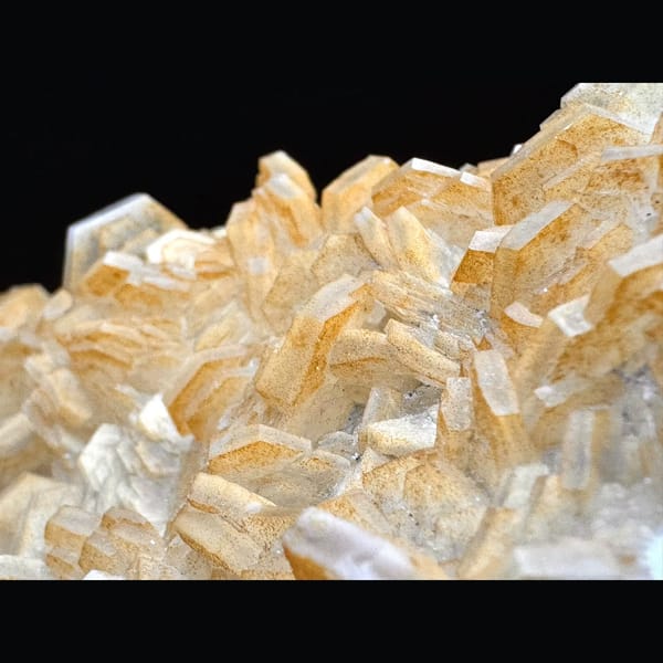 Pale yellow layered calcite blades on a plate from Fujian — detail view