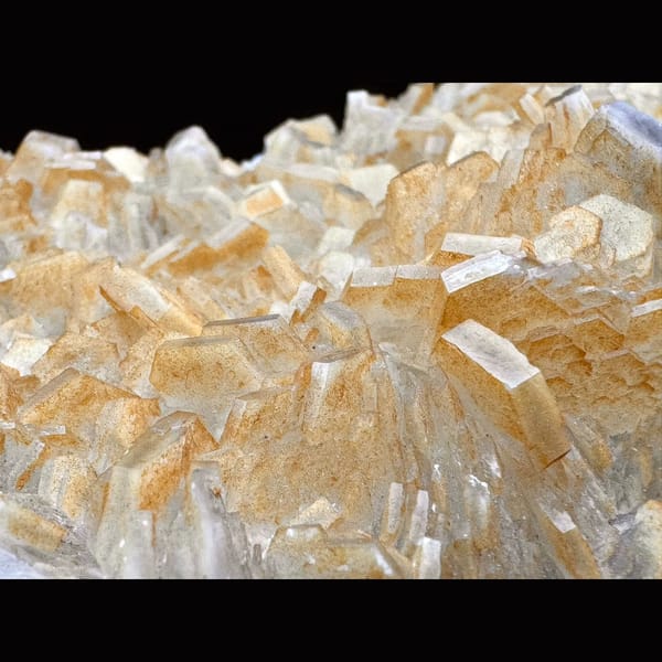 Pale yellow layered calcite blades on a plate from Fujian — detail view