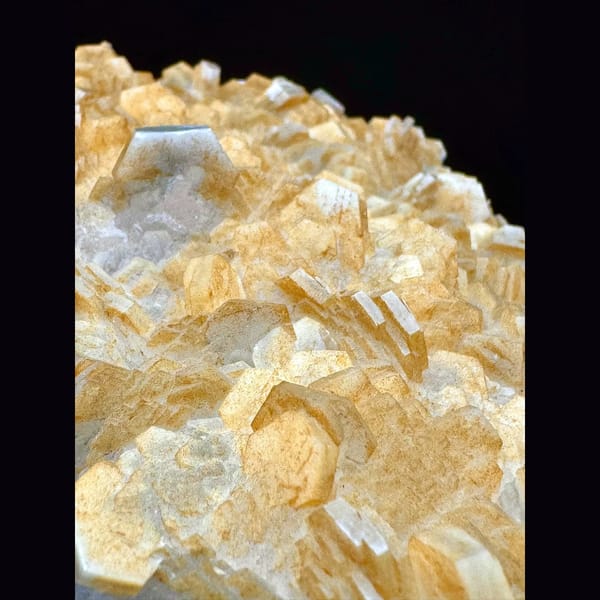 Pale yellow layered calcite blades on a plate from Fujian — detail view
