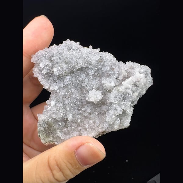 Pale green fluorite crystal in sparkling white quartz druse from Fujian — alternate view