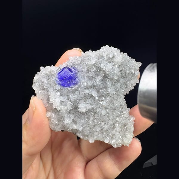 Pale green fluorite crystal in sparkling white quartz druse from Fujian — detail view